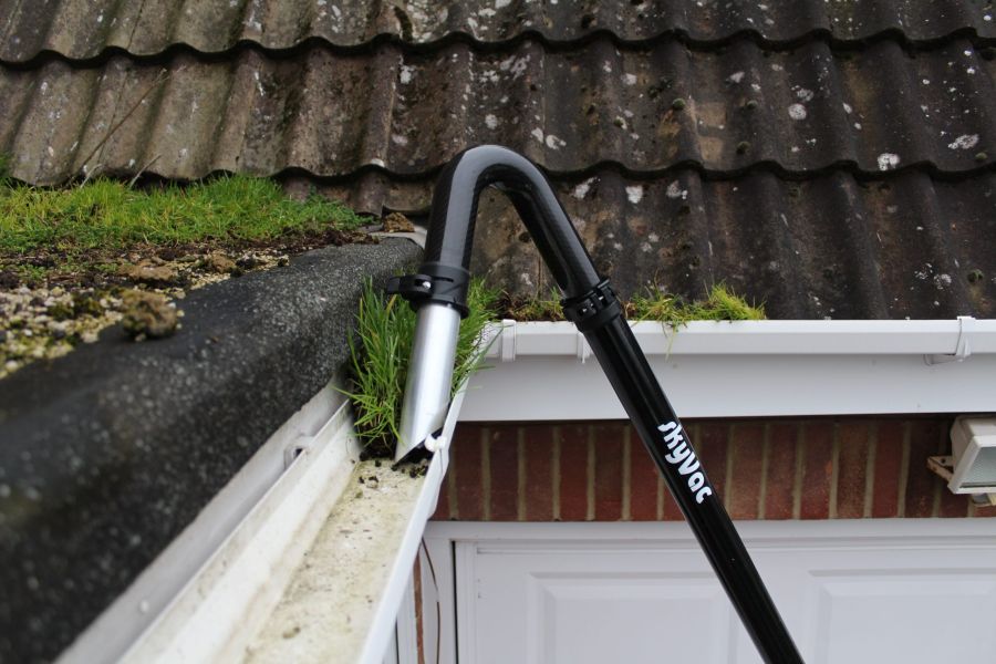 gutter vacuum removing roof moss