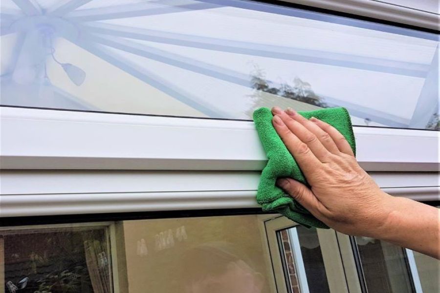 Man cleaning a conservatory
